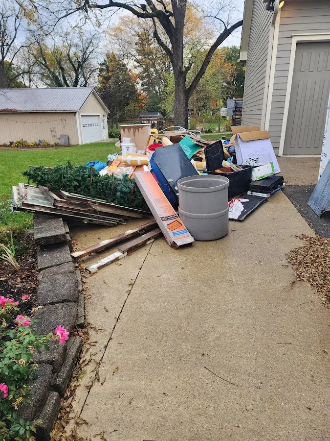 Dumpster being loaded with debris for Estate Cleanout Dumpster Rental in Zillah
